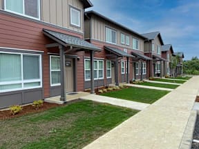 A row of houses with brown and grey siding.