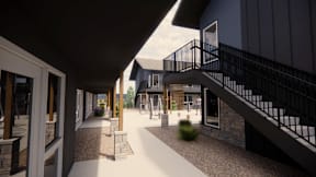 A modern building with a black railing and a white walkway.