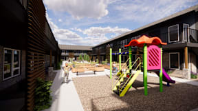 A playground with a slide and a child on a scooter.