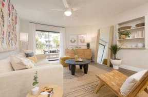 a living room with a white couch and a wooden coffee table