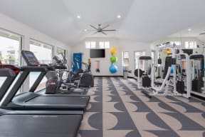 a gym with treadmills and other exercise equipment