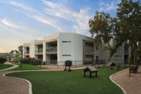 a building with a lawn and trees in front of it