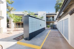 a parking lot with a blue garage door and a white building in the background