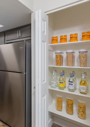 a pantry with a refrigerator next to it