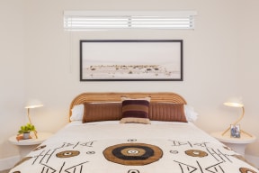a bedroom with a bed and two night stands with lamps