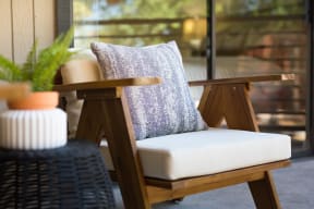 a chair with a cushion on it on a patio