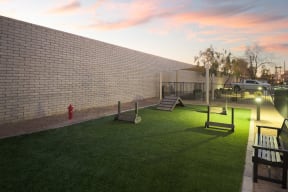 a backyard with a fire hydrant and swings and a play yard