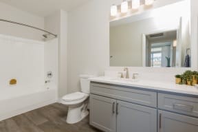 a bathroom with a sink toilet and a mirror