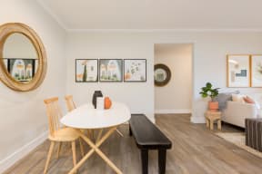 a dining room with a white table and chairs and a living room