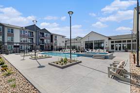 A pool area with a small fountain in the middle of the pool.