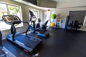 a home gym with treadmills and other exercise equipment