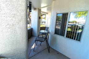 a balcony with a chair and a table