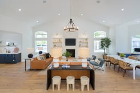 a large living room with white walls and hardwood flooring