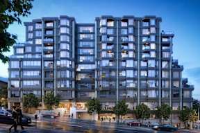 A large, modern apartment building with many windows and balconies.