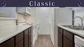A kitchen with brown cabinets and white appliances.