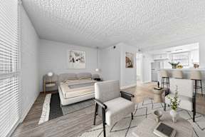 A bedroom with a bed, chair, and a table.