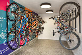 A bike shop with bikes hanging on the wall.