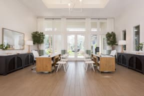 a living room with wooden floors and a table and chairs