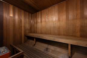 A wooden bench in a room with wooden walls.