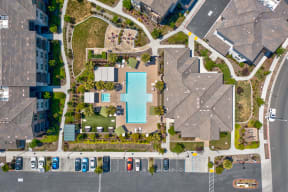 a house with a large pool in the middle of a parking lot