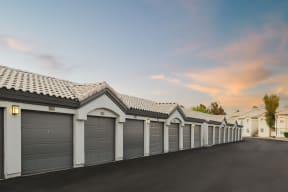 a row of garages with a sunset in the background