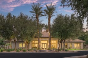 the facade of a building with palm trees in front of it