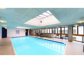a large swimming pool with a skylight above it