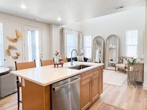 A kitchen with wooden cabinets and a white countertop.
