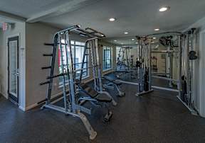 A gym with a variety of equipment including a leg press machine.