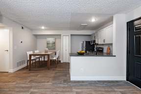A kitchen with a table and chairs in the middle of the room.