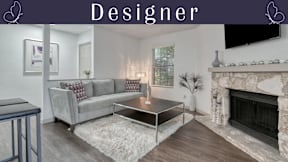 A living room with a grey couch and a coffee table.