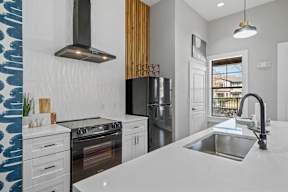 a kitchen with a sink and a stove and a refrigerator