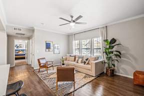 a living room with a couch and a ceiling fan