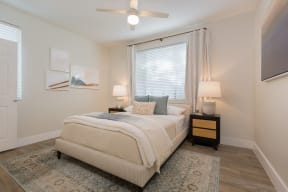 a bedroom with a bed and a ceiling fan