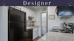 A kitchen with a black fridge and a title "Designer" at the top.