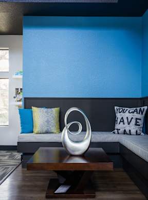 A blue wall with a white pillow and a sign that says "You can have stall".