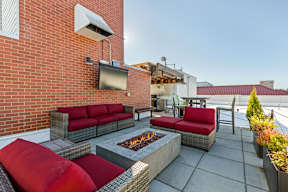 A patio with a fire pit and seating area.