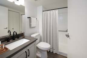 A white toilet sits next to a sink in a bathroom.