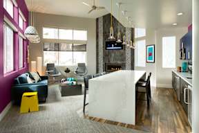 A modern kitchen with a large island and a dining area.
