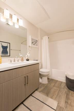 A bathroom with a white toilet and a white sink.