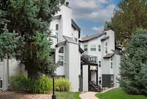 A white house with a black staircase.