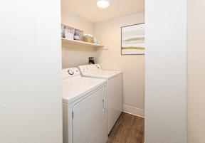 A small laundry room with a washer and dryer.