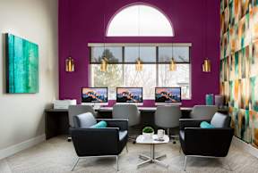 A room with purple walls and a large window with a view of trees.