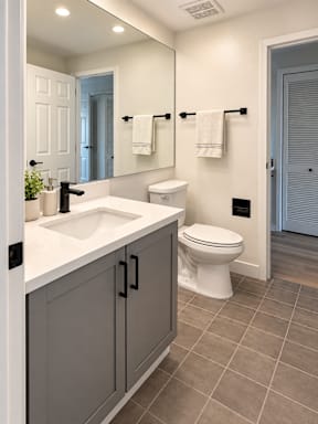 A bathroom with a white toilet and a white sink.