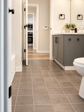 A bathroom with a toilet, sink and a door.