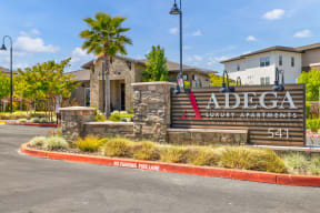 an image of the adecca community sign with a building in the background