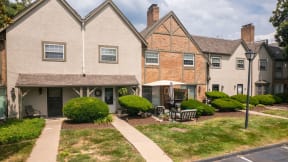 the view of the front of a house with a yard and a sidewalk