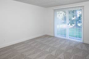 A room with a car visible through the window.