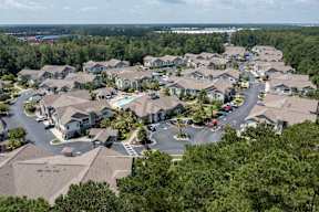 A bird's eye view of a residential area with houses and trees.