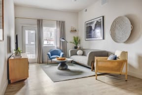 a living room with a couch and a chair and a sliding glass door